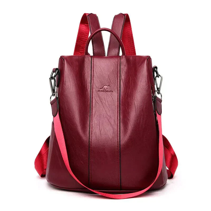 A stylish women's backpack with a sleek design, featuring a sturdy handle, adjustable shoulder straps, and side hooks for versatile carrying options. The bag has a smooth finish and a spacious main compartment, ideal for everyday use or travel.