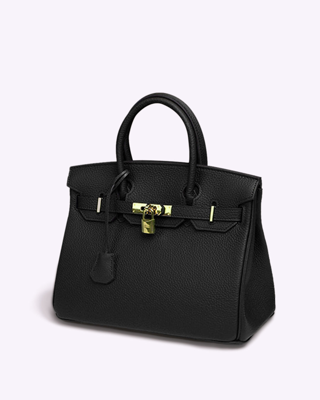 Image showing a woman holding an elegant handbag with a sleek design, featuring gold hardware and a structured shape, paired with casual attire for a stylish, sophisticated look.