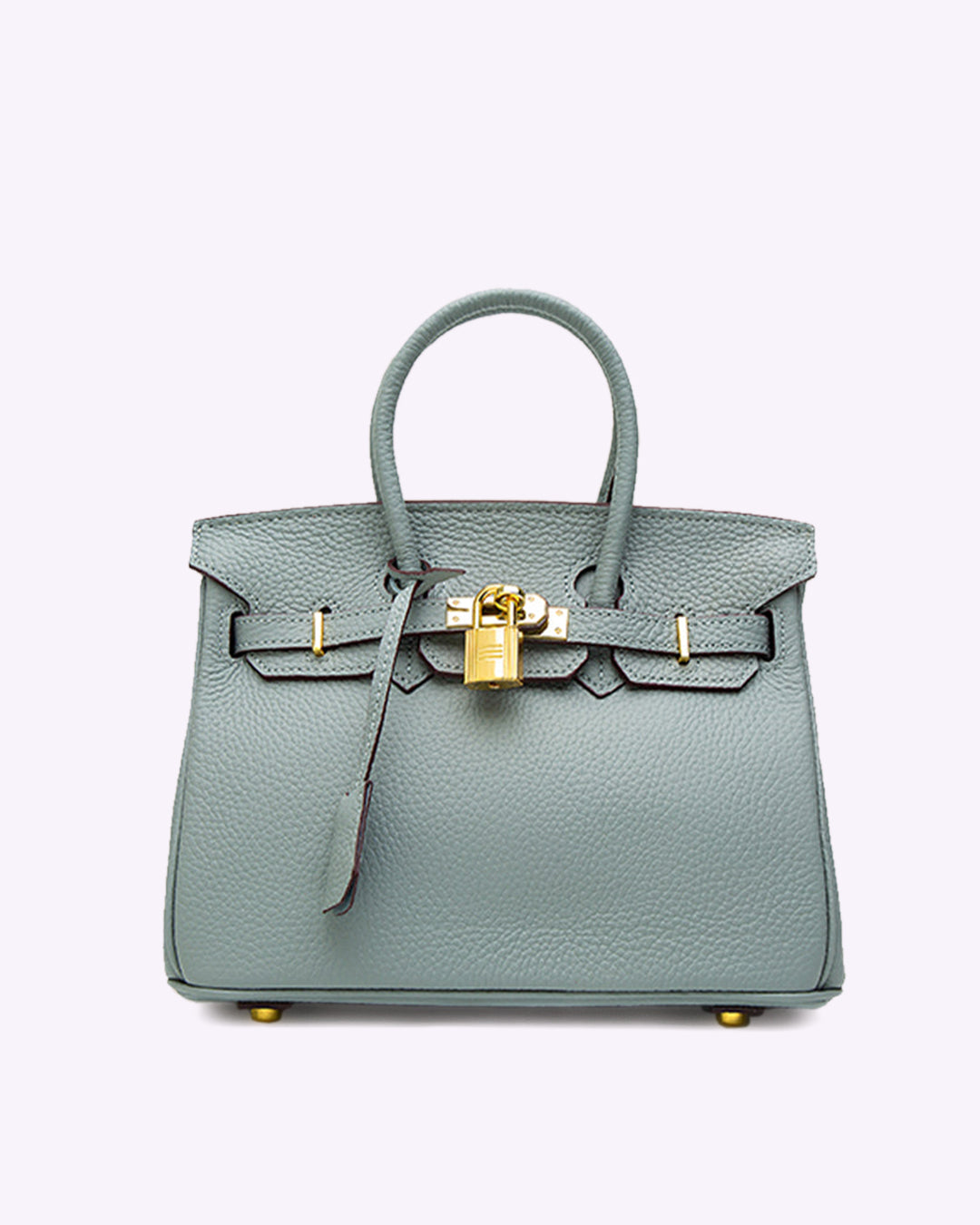 Image showing a woman holding an elegant handbag with a sleek design, featuring gold hardware and a structured shape, paired with casual attire for a stylish, sophisticated look.