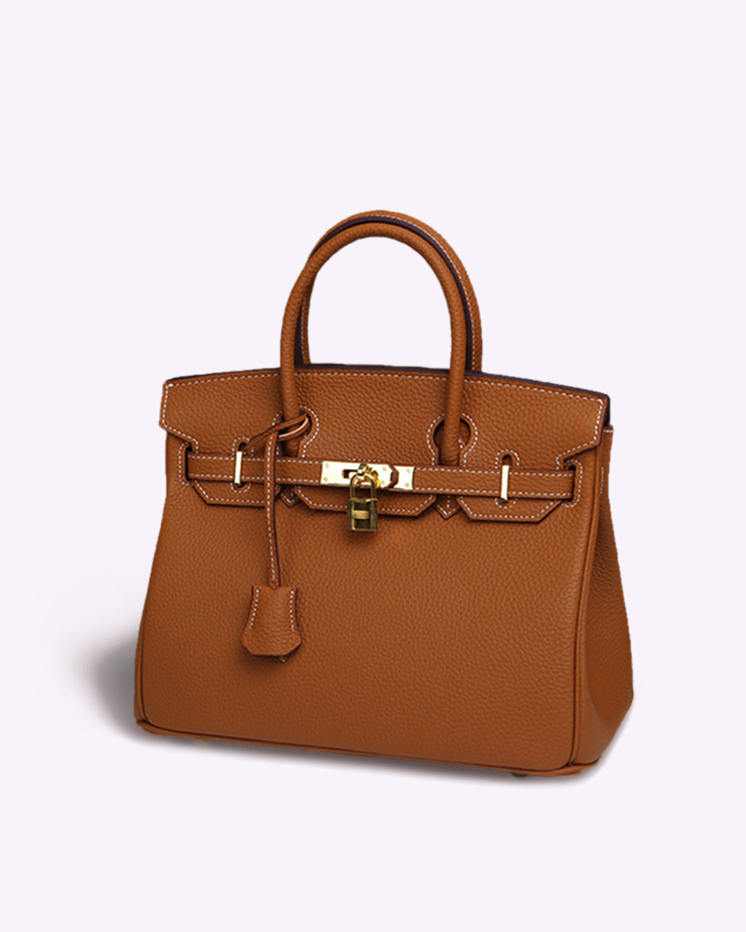 Image showing a woman holding an elegant handbag with a sleek design, featuring gold hardware and a structured shape, paired with casual attire for a stylish, sophisticated look.